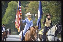 Photograph of women on horseback carrying flags during 1976 ECU Homecoming parade